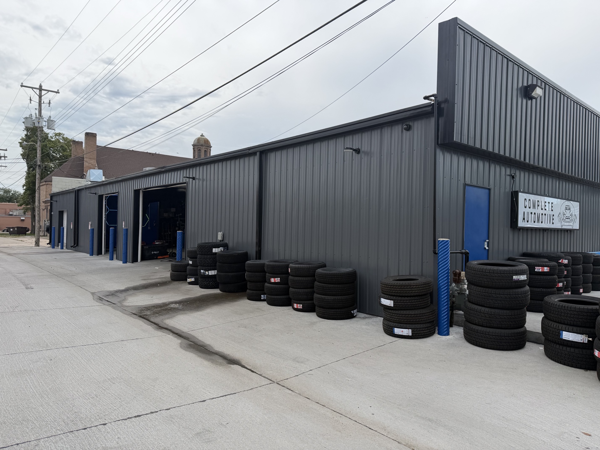 Complete Automotive and Tires north-side service doors with tire inventory